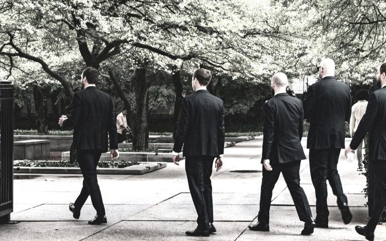 Group of men in suits walking outdoors, symbolising leadership, confidence, and Vision for Personal Growth in daily life.