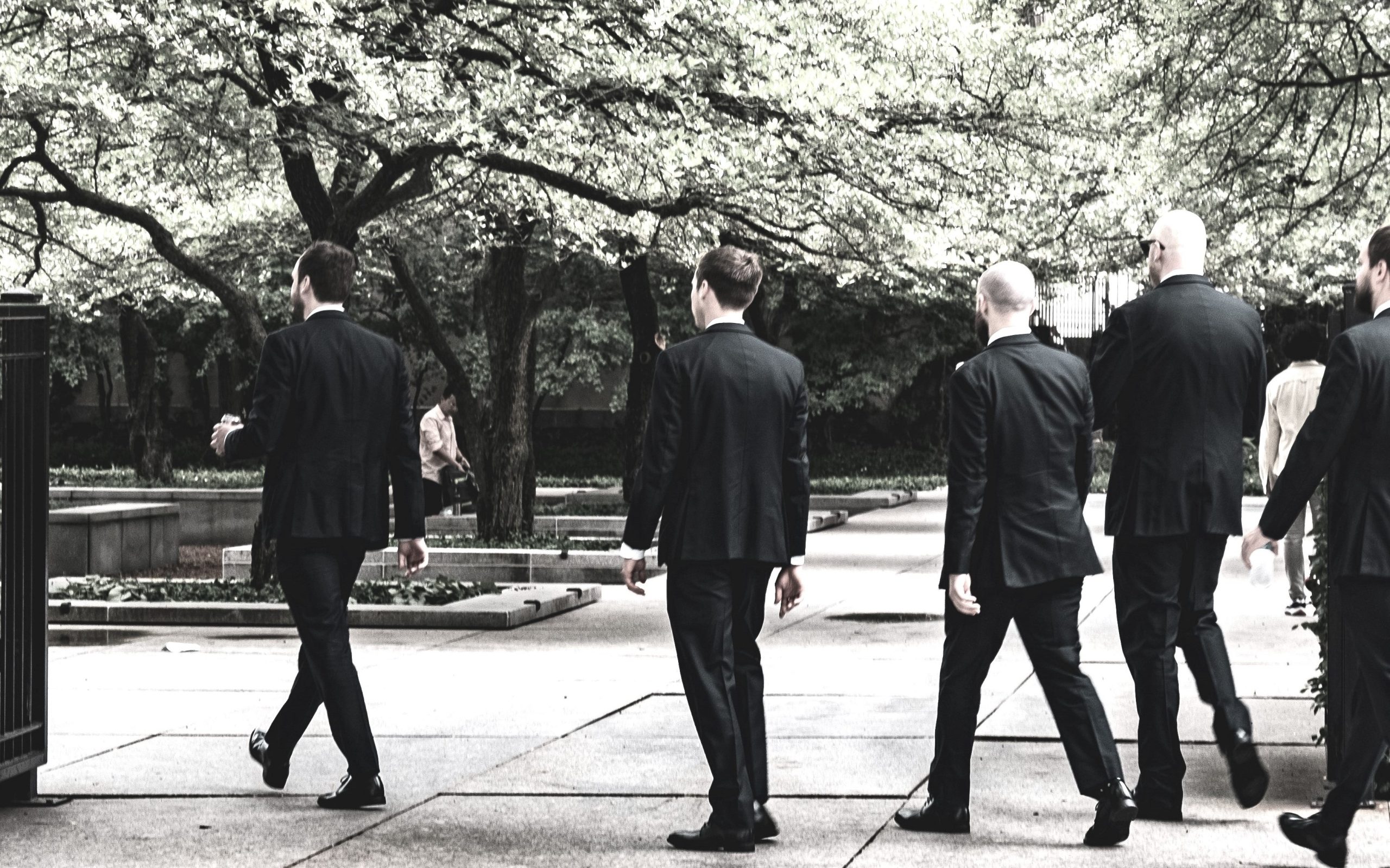 Group of men in suits walking outdoors, symbolising leadership, confidence, and Vision for Personal Growth in daily life.