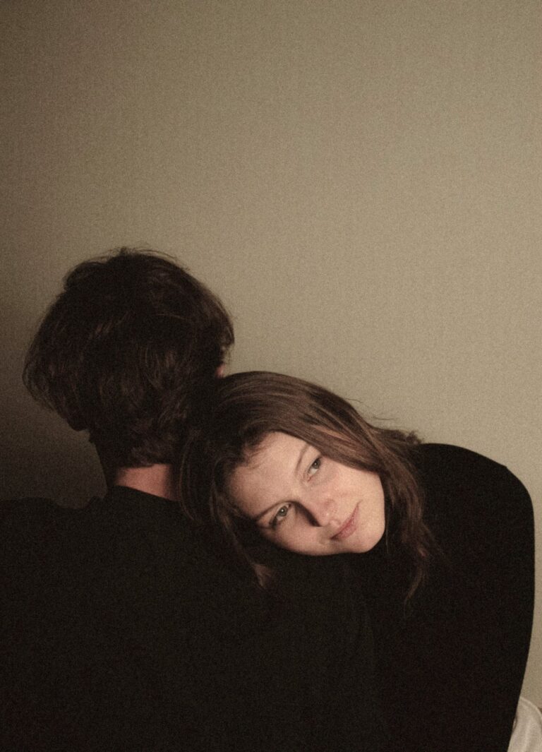 Woman resting on partner’s shoulder shows support for women suffering from Dyspareunia and Therapy needs.