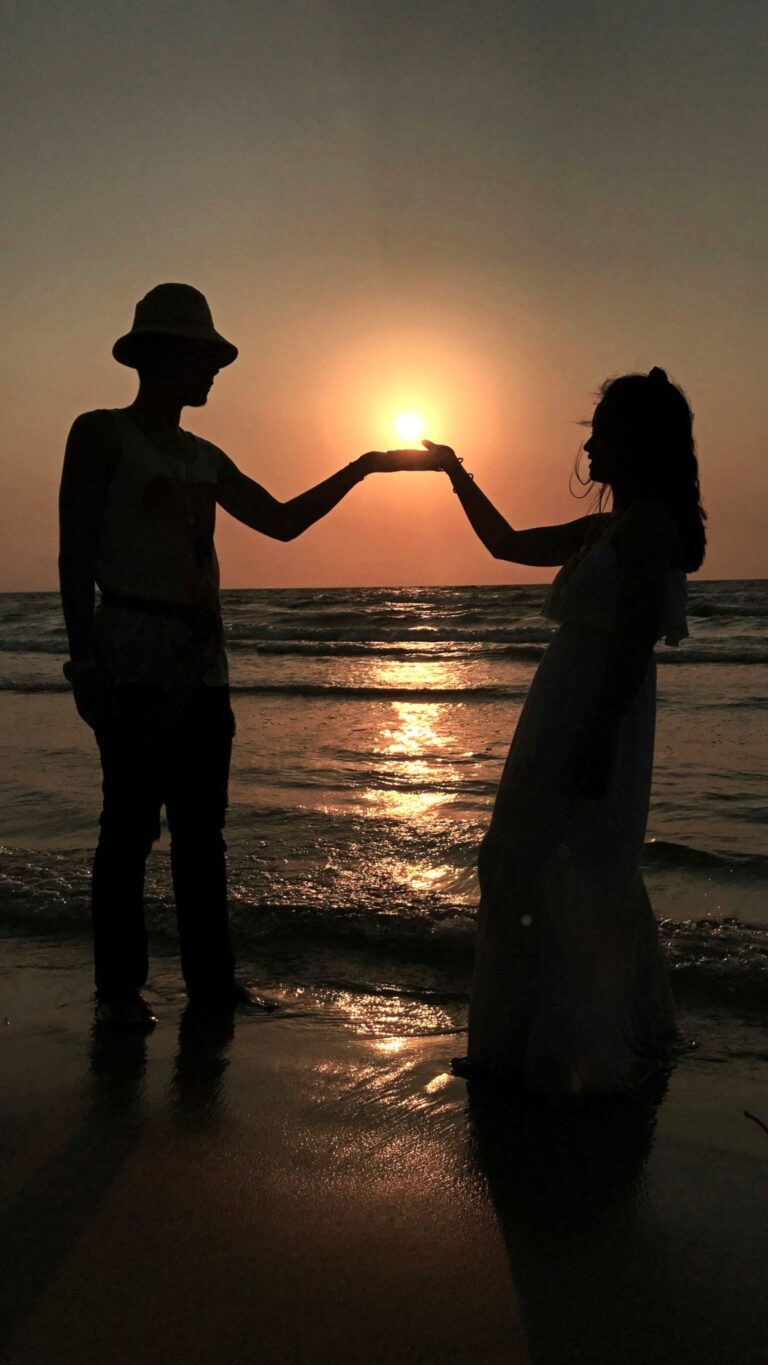 Couple holding hands at sunset reflecting modern attachment styles and Attachment Behaviors In Couples.