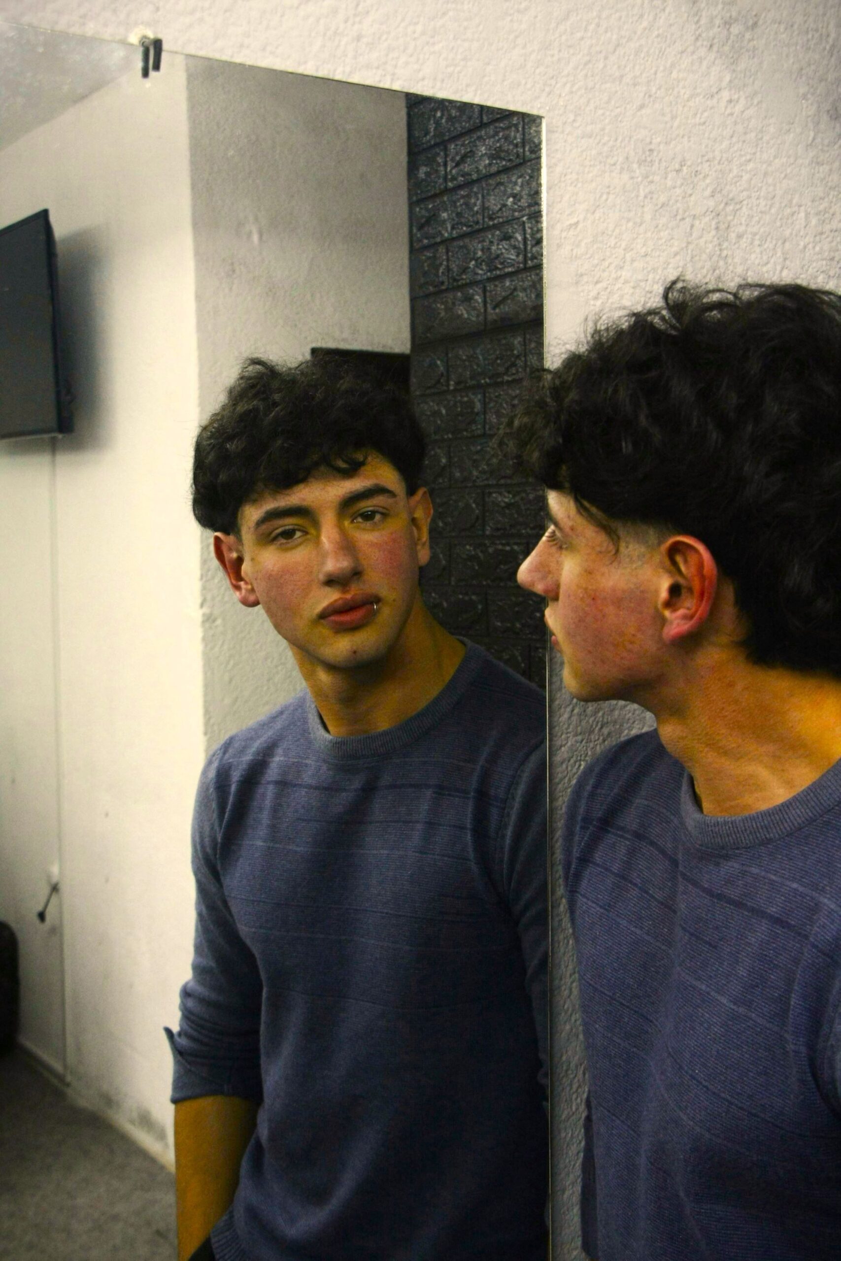 Man looks into mirror, reflecting growing dissatisfaction shaped by high expectations and need to Love Yourself Beyond Flaws.