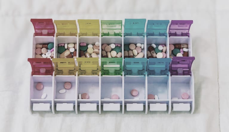 Pill organiser filled with medication, symbolising daily care and Improving Trust with Relatives in mental illness.