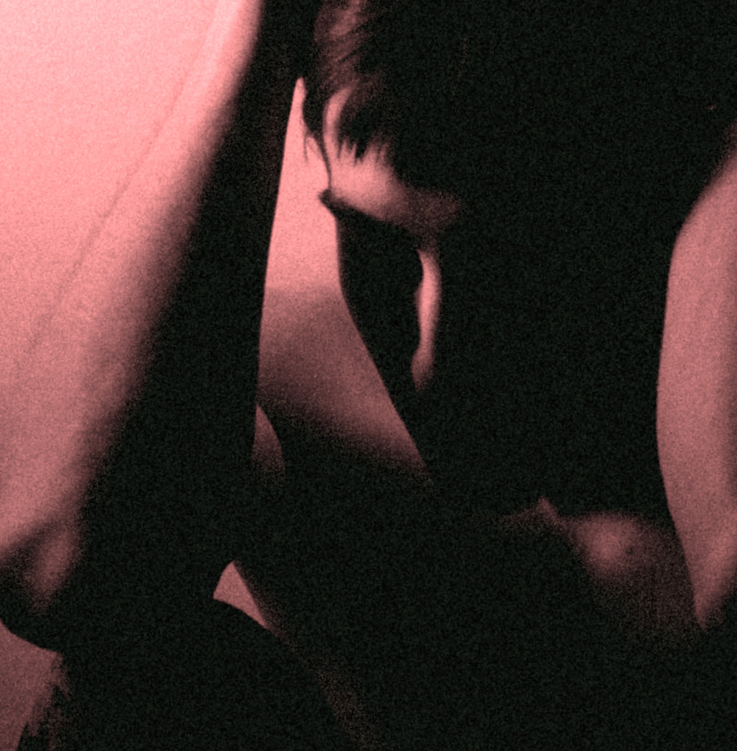 Deeply introspective person sitting in a dark, emotional state, possibly experiencing distress or mental health challenges, captured in a moody, contemplative setting.