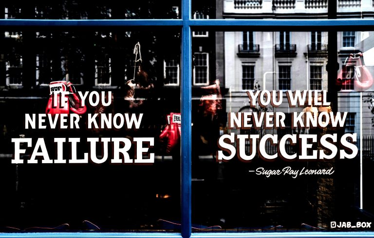 Window with motivational quote about failure and success, symbolising Reflective Listening and supporting relatives with empathy.