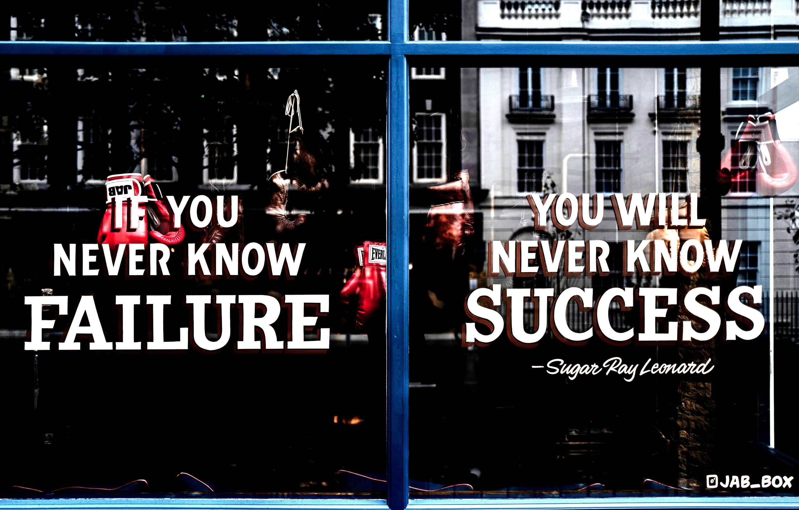 Window with motivational quote about failure and success, symbolising Reflective Listening and supporting relatives with empathy.