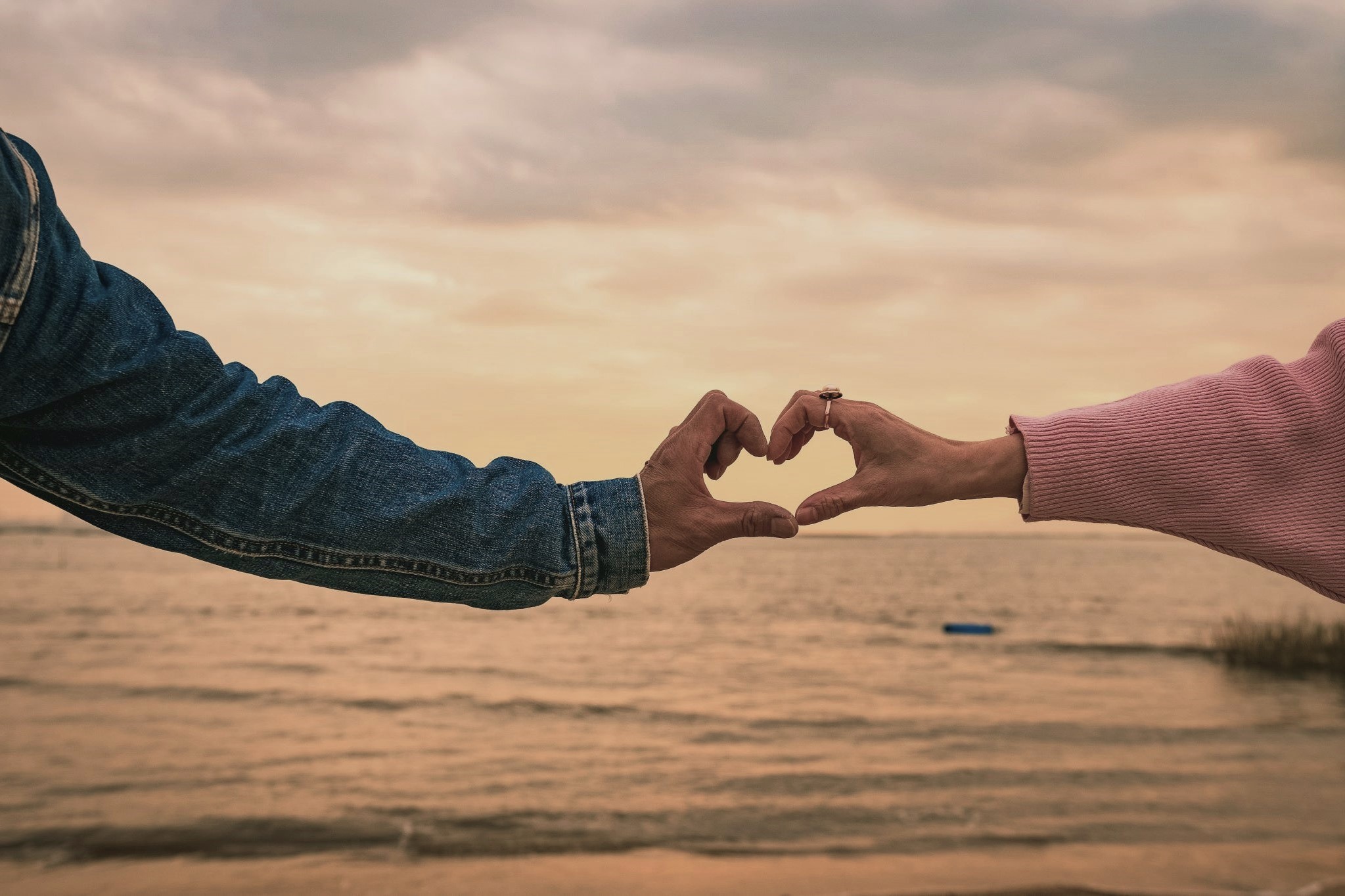 Romantic couple forming heart with hands, showing trust where boundaries and consent are a must for safe intimacy Focusing On Protection.