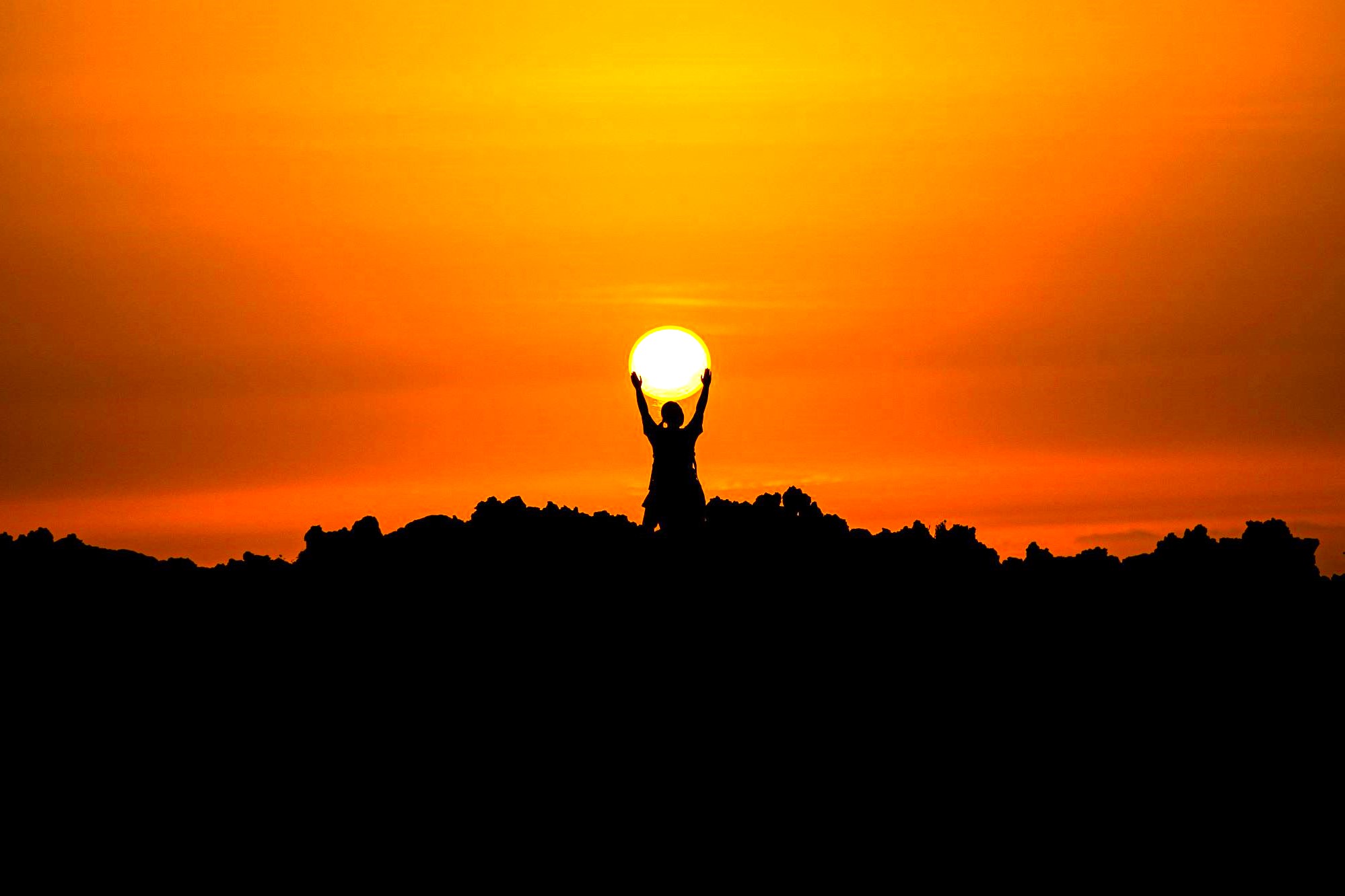 A woman holding sunlight, whilst coping differently with grief and finding hope through Grief Support For Families.