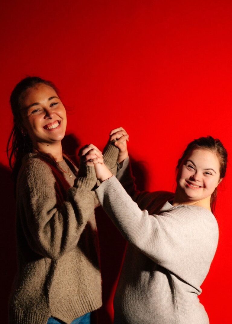 Two best friends hugging tightly, as one is moving to another country, showing how it naturally hurts Accepting Difficult Changes.