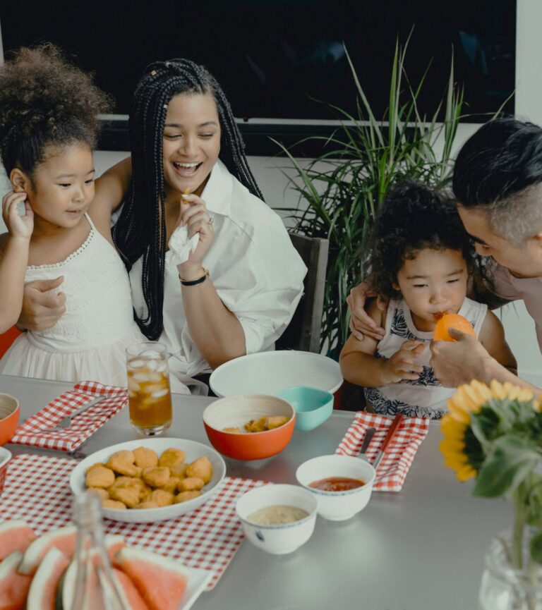 Parents guiding children at dinner while managing mealtime battles and encouraging calmer family meals thanks to Child Mealtime Struggles.