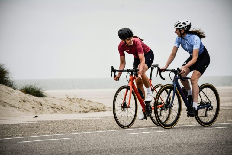 Cyclists enjoying an uplifting coastal ride, showing how biking improves mood, outlook and confidence through Outdoor Bike Practice.