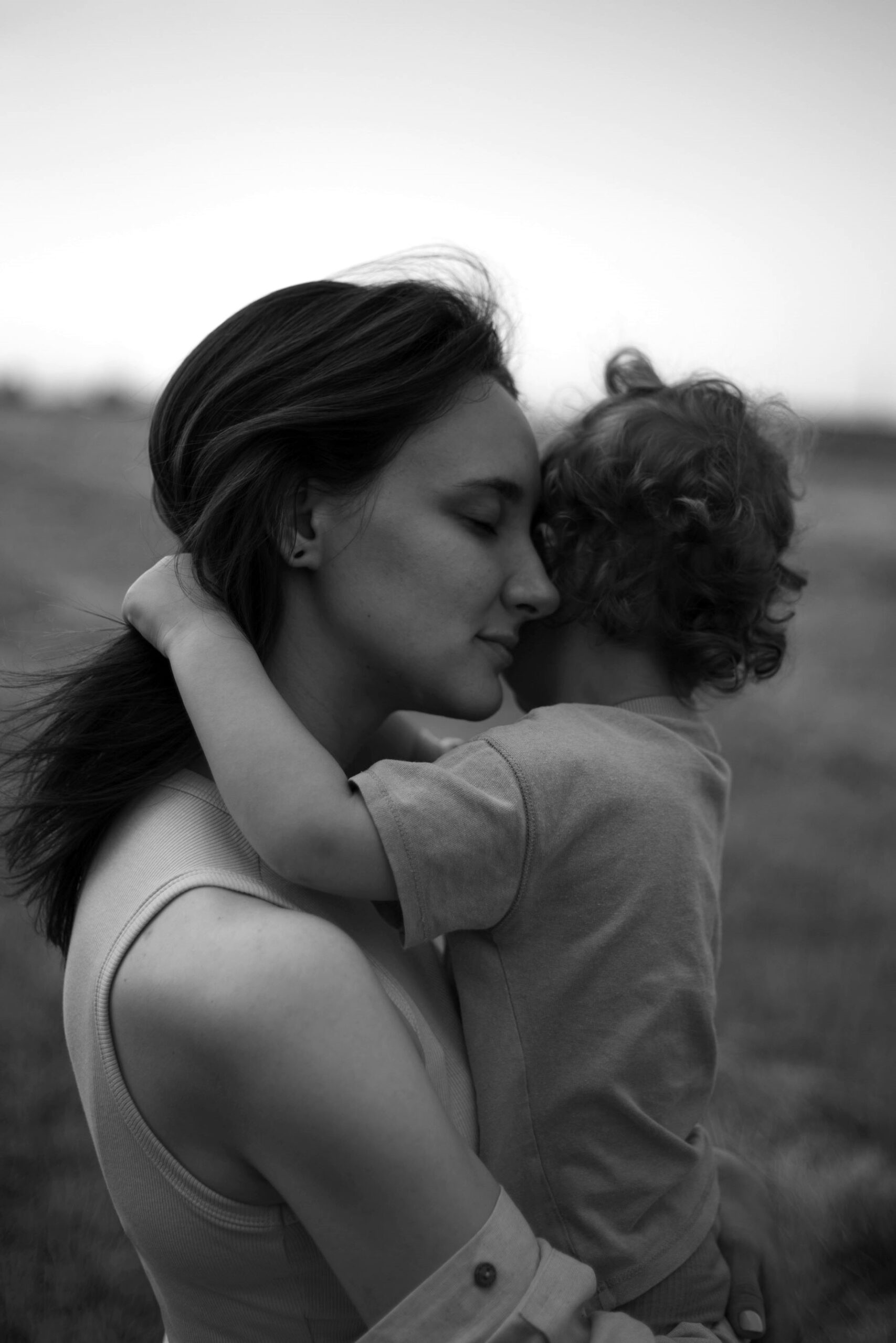 Mother comforting child while explaining death in an age appropriate way, helping children understand loss Questions About Funerals.