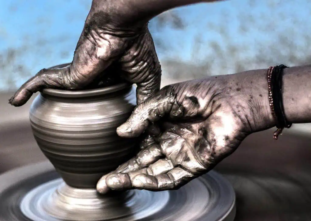Unskilled hands shaping clay on a pottery wheel, symbolising creativity, mindfulness, and therapeutic expression.