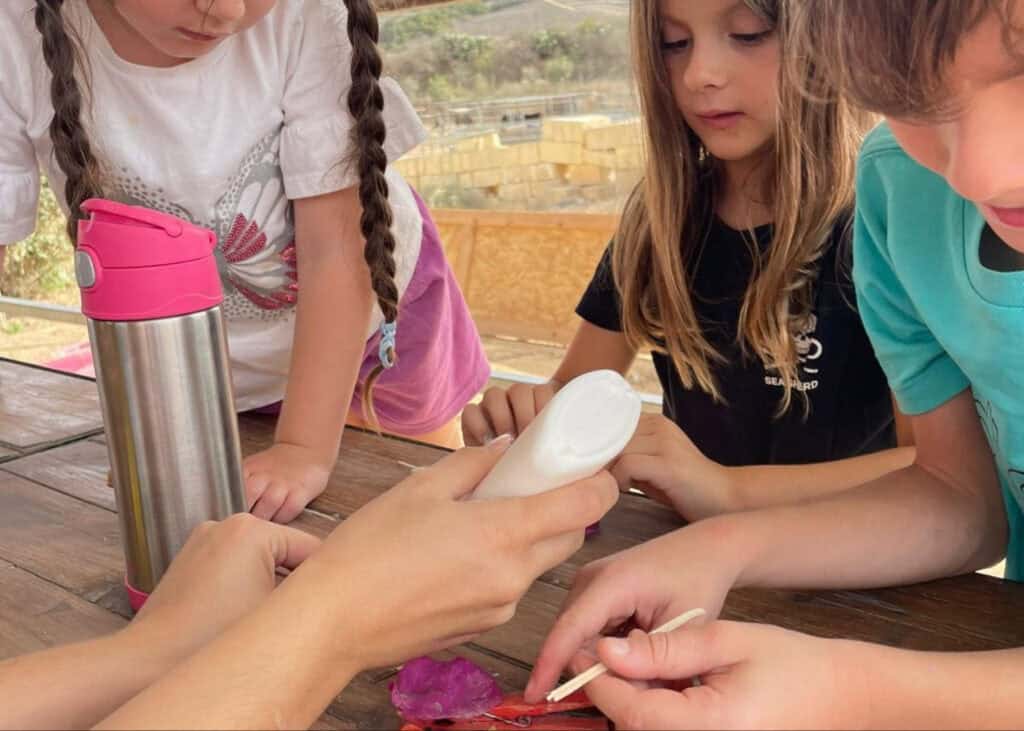 Meditation, mindfulness, or mental health therapy session involving children, focusing on calmness and emotional wellbeing, with kids engaged in a moment of reflection or guided activity outdoors.