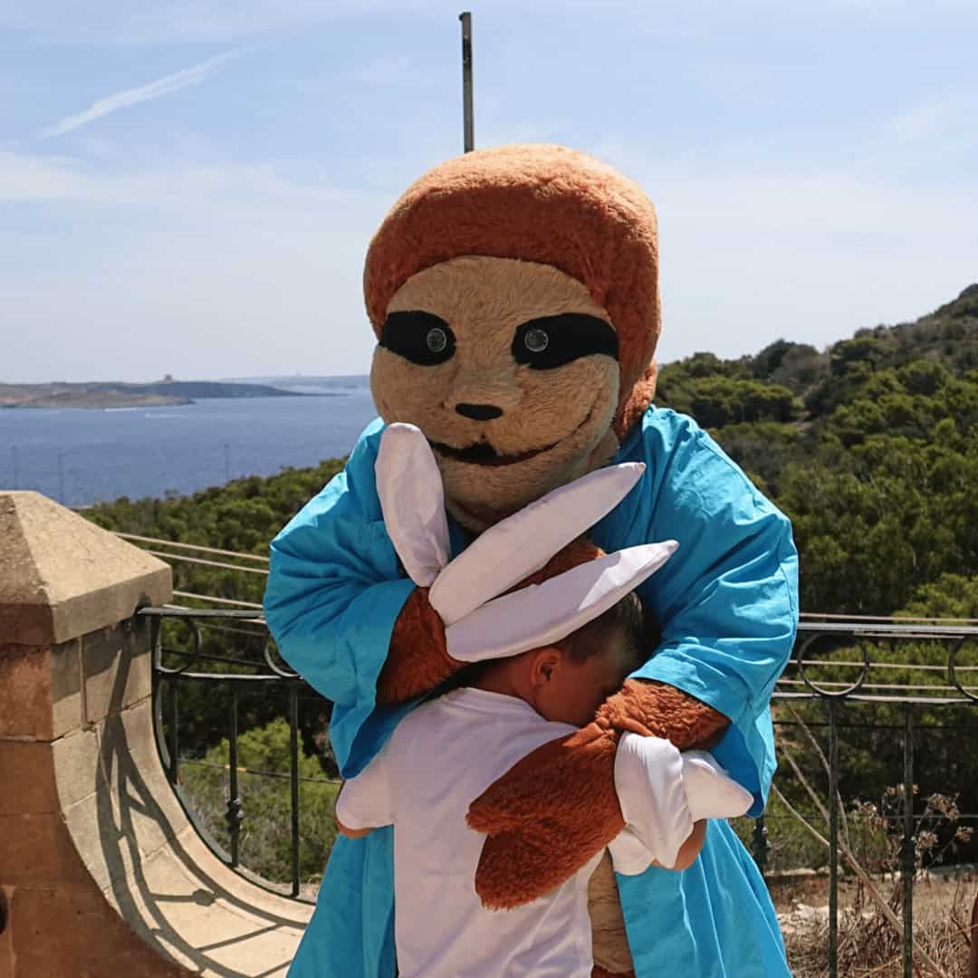 Sig the sloth comforting a child at Mindfulness Camp for Kids.