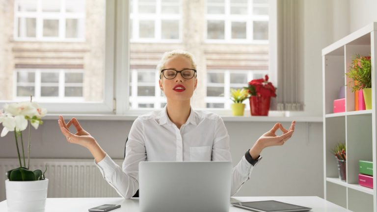 a woman who meditates at work