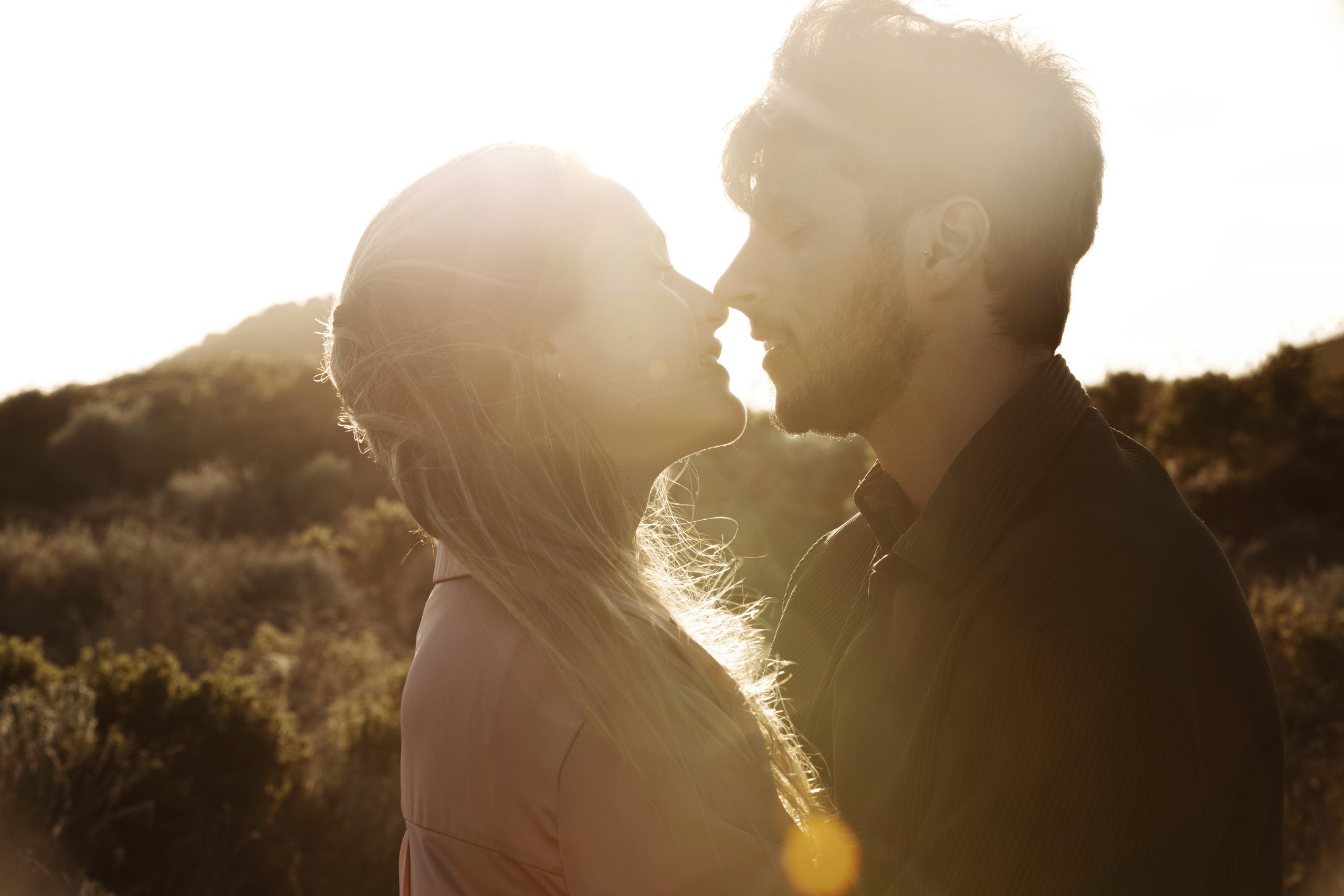 a couple with a sunset