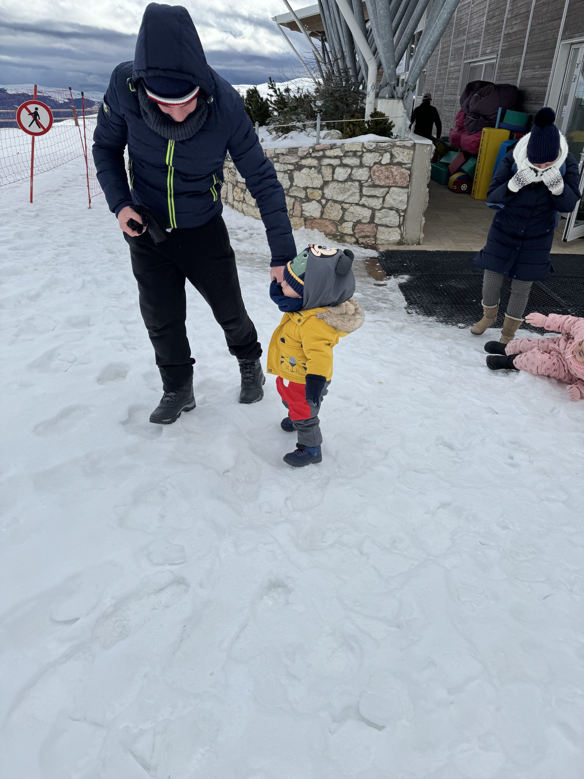 a father and child in the snow