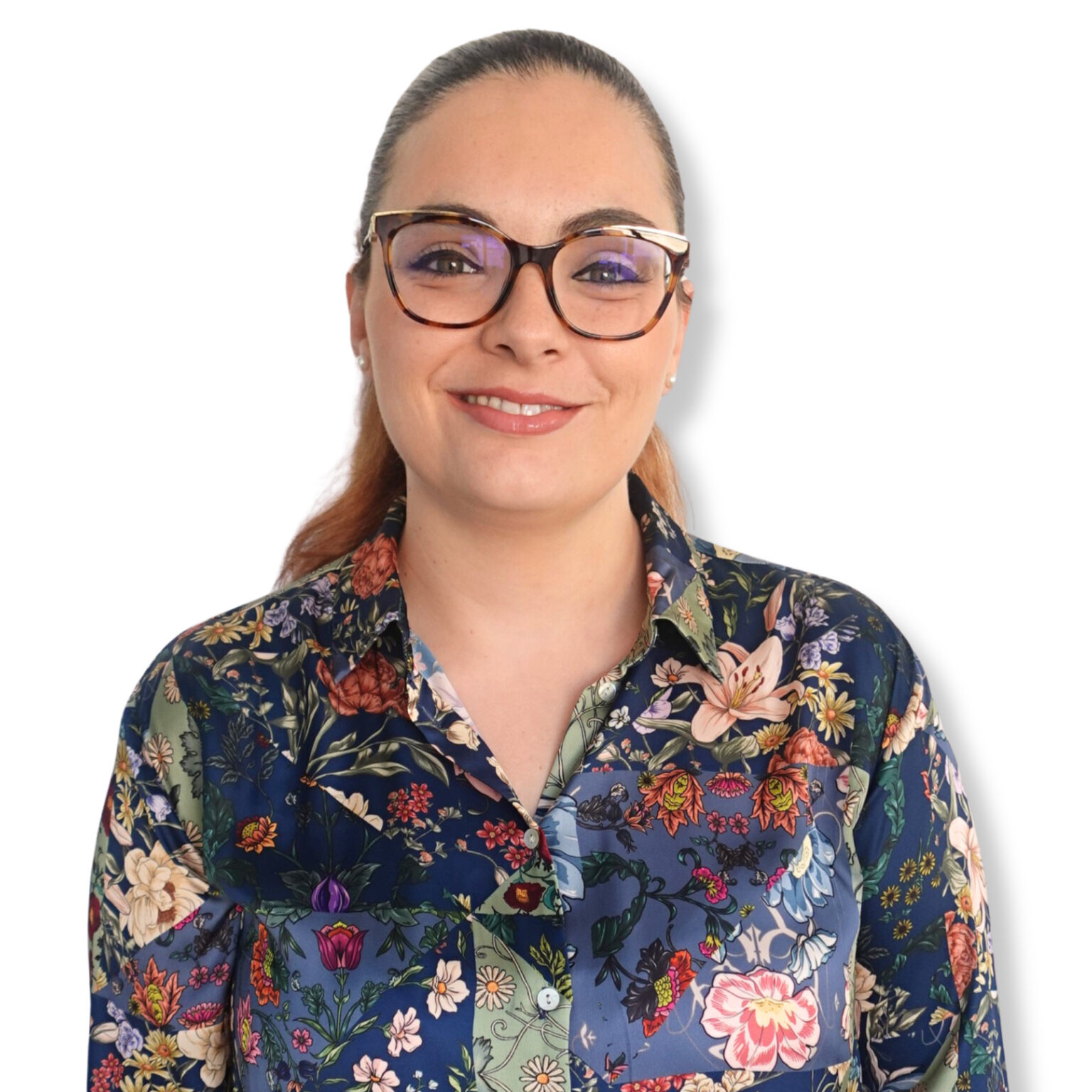 Calm professional woman smiling wearing glasses and a floral blouse reflecting positivity mental health awareness.