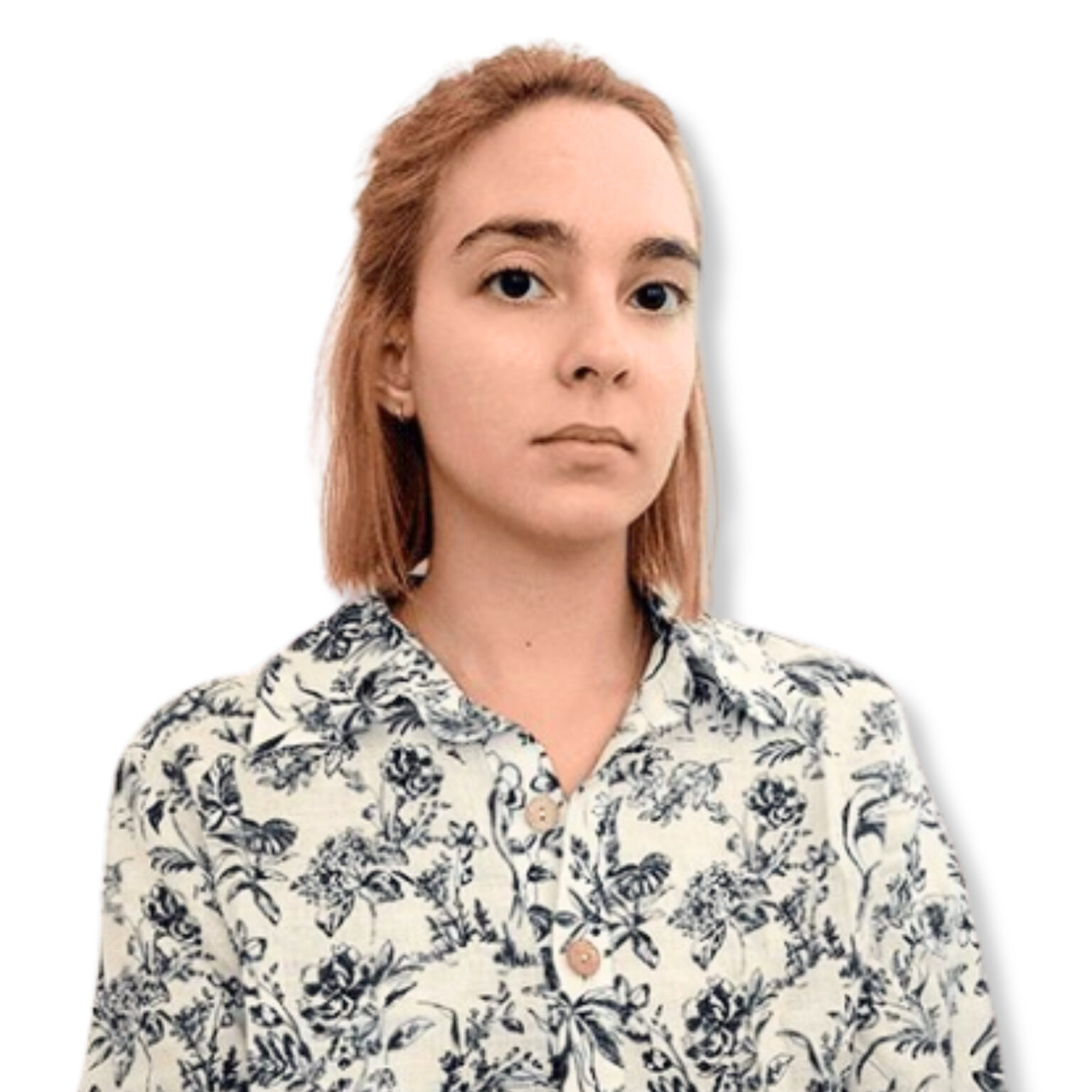 Calm young woman with shoulder-length reddish hair and a neutral expression, wearing a floral blouse, against a plain white background.