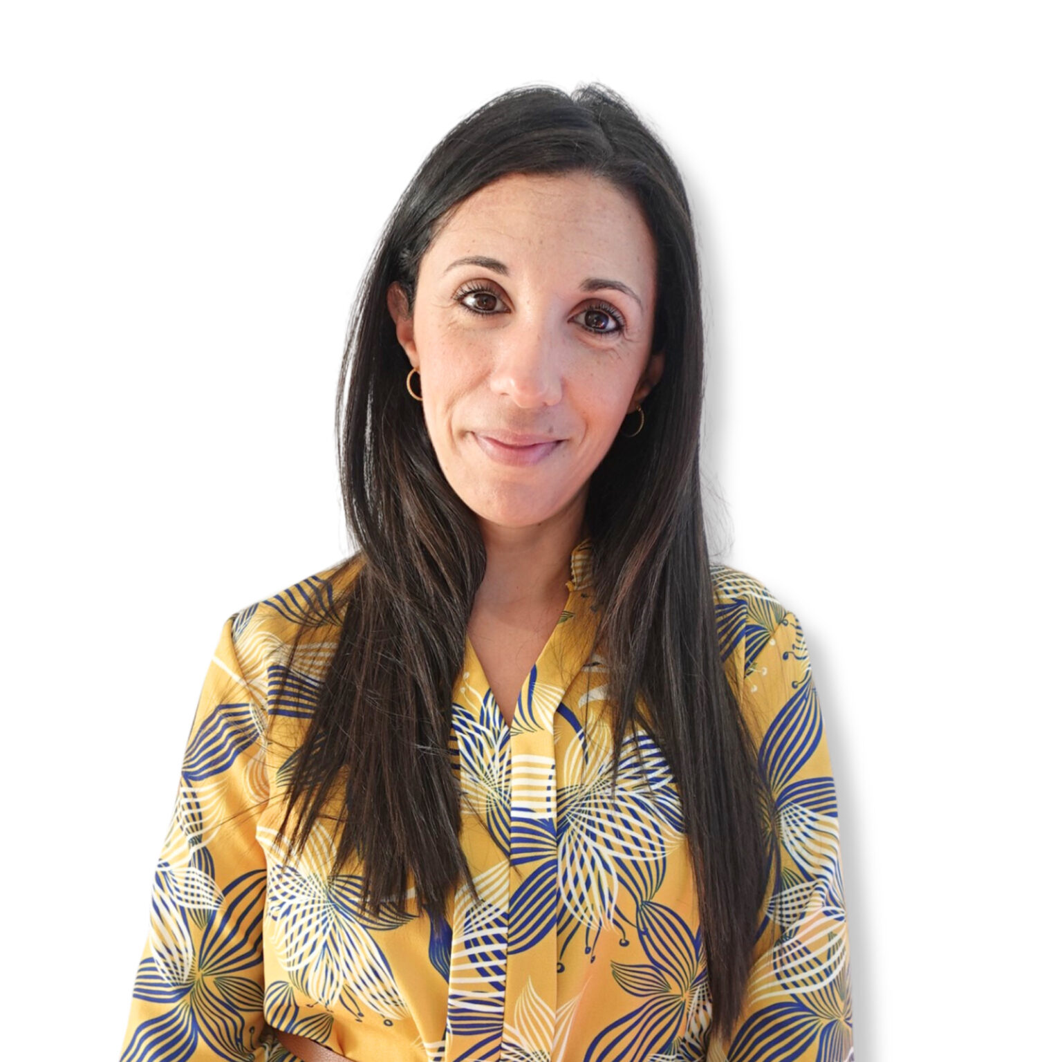 Calm woman with dark hair and a gentle smile on a white background, dressed in a colourful patterned top, conveying a sense of mental clarity and emotional well-being.