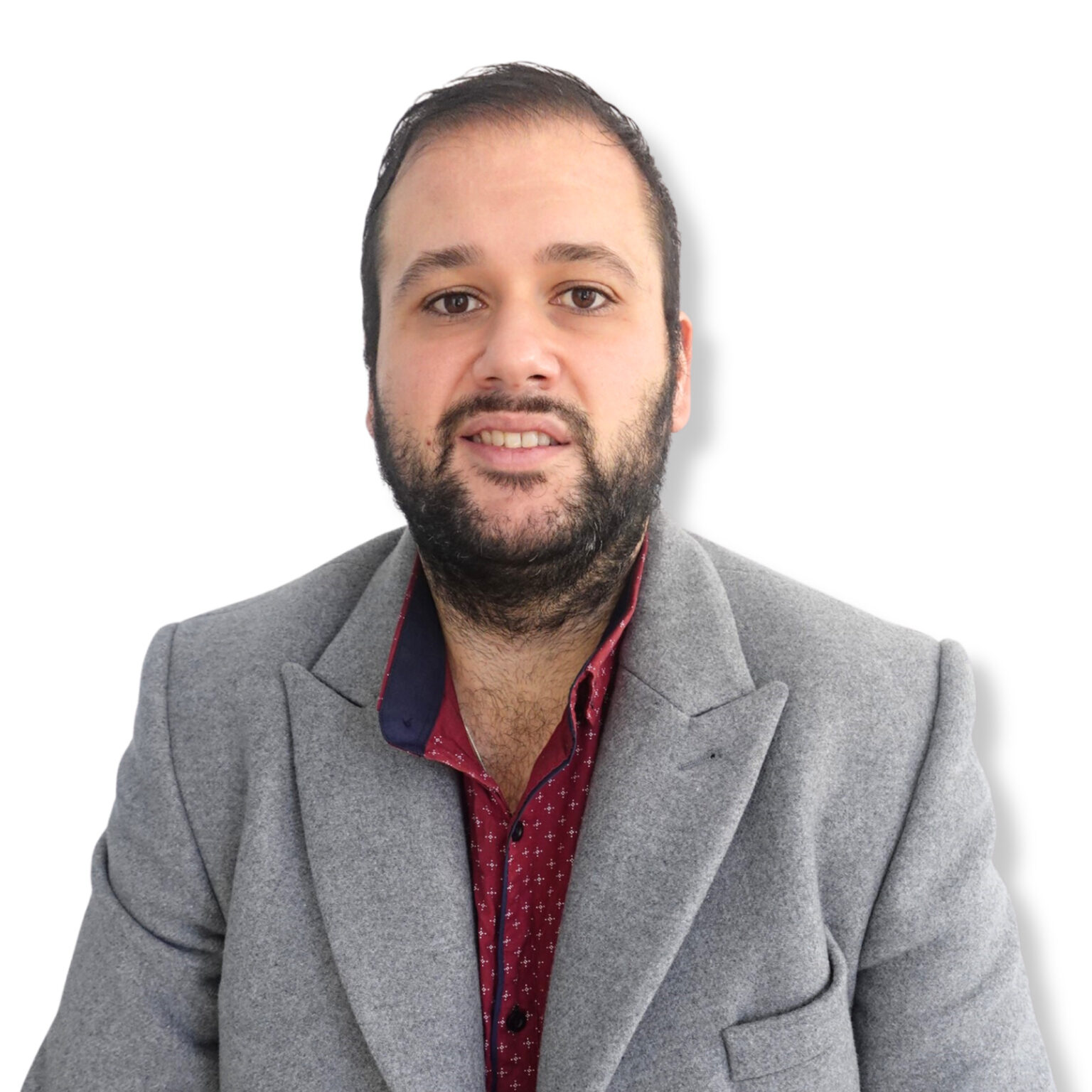 Calm professional man in a grey blazer and red shirt, representing a mental health expert or psychologist.