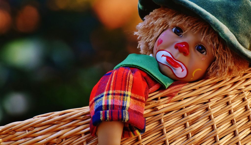 In this photo, we can see a clown doll, that isn't smiling, as like a minor reference to the fact that some parents experience sadness while parenting. However, there are actually methods to use that can make sadness management while parenting possible.
