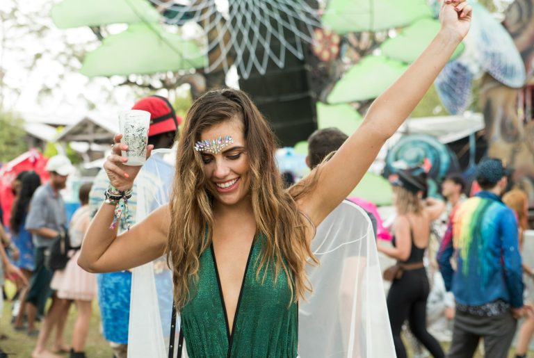 A woman is shown enjoying herself at a festival celebrating her country's tradition. Despite what we often see, enjoying a festival without having any alcohol, while not common, is not impossible.