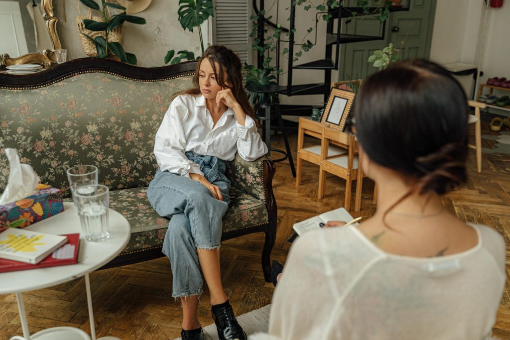 A therapist is shown hosting a therapy session with her client, who's unfortunately not looking better due to feelings of dissociation.