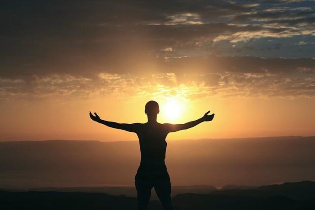 A person embracing the sunset in a comfortable environment, feeling thankful to have been given the opportunity to live life to the fullest. It's the power of everyday gratitude.