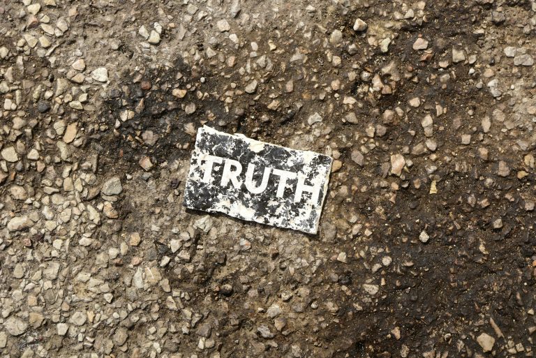 A worn sign reading 'TRUTH' on rough ground, symbolising clarity and facts about EMDR therapy myths.
