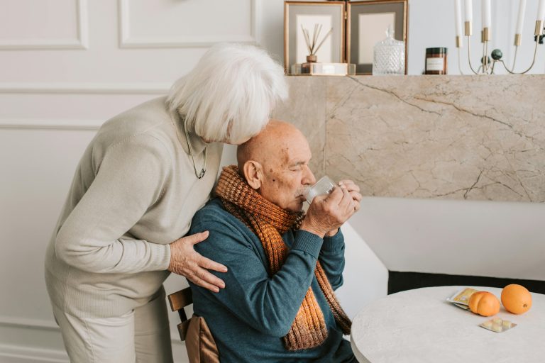 Elderly woman supporting loved one with chronic illness at home.