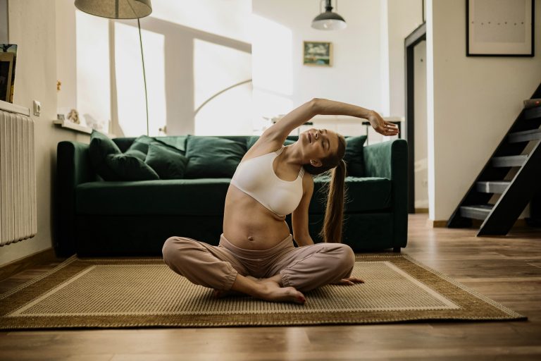 Woman stretching indoors showing how exercise supports mental clarity.