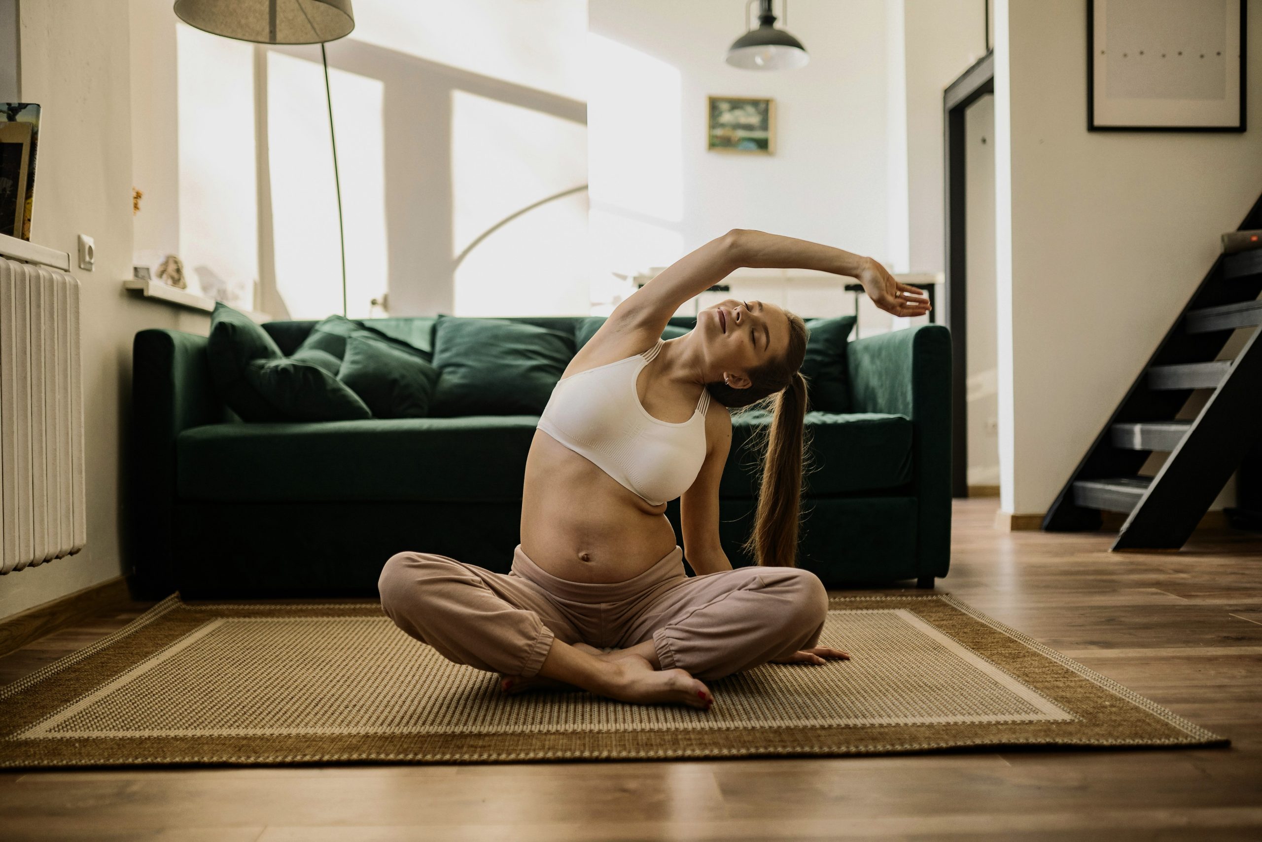 Woman stretching indoors showing how exercise supports mental clarity.