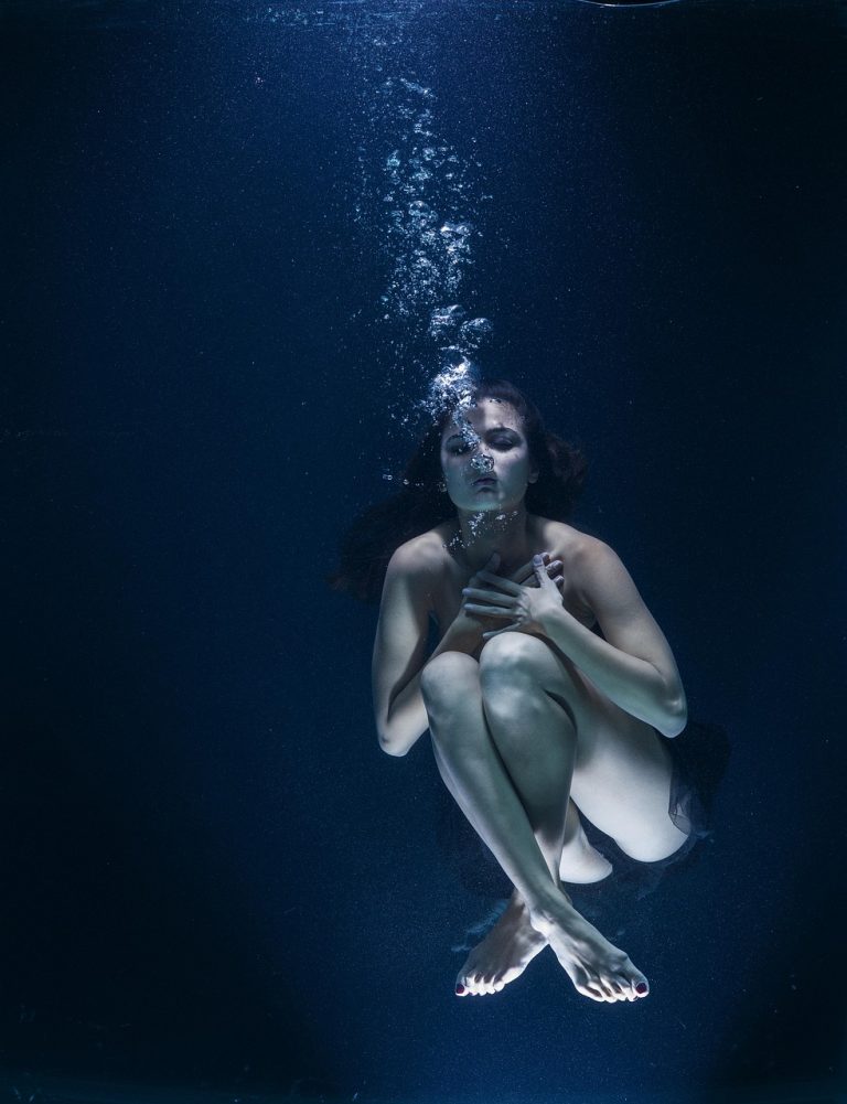 Woman underwater symbolising emotional benefits of being in water.