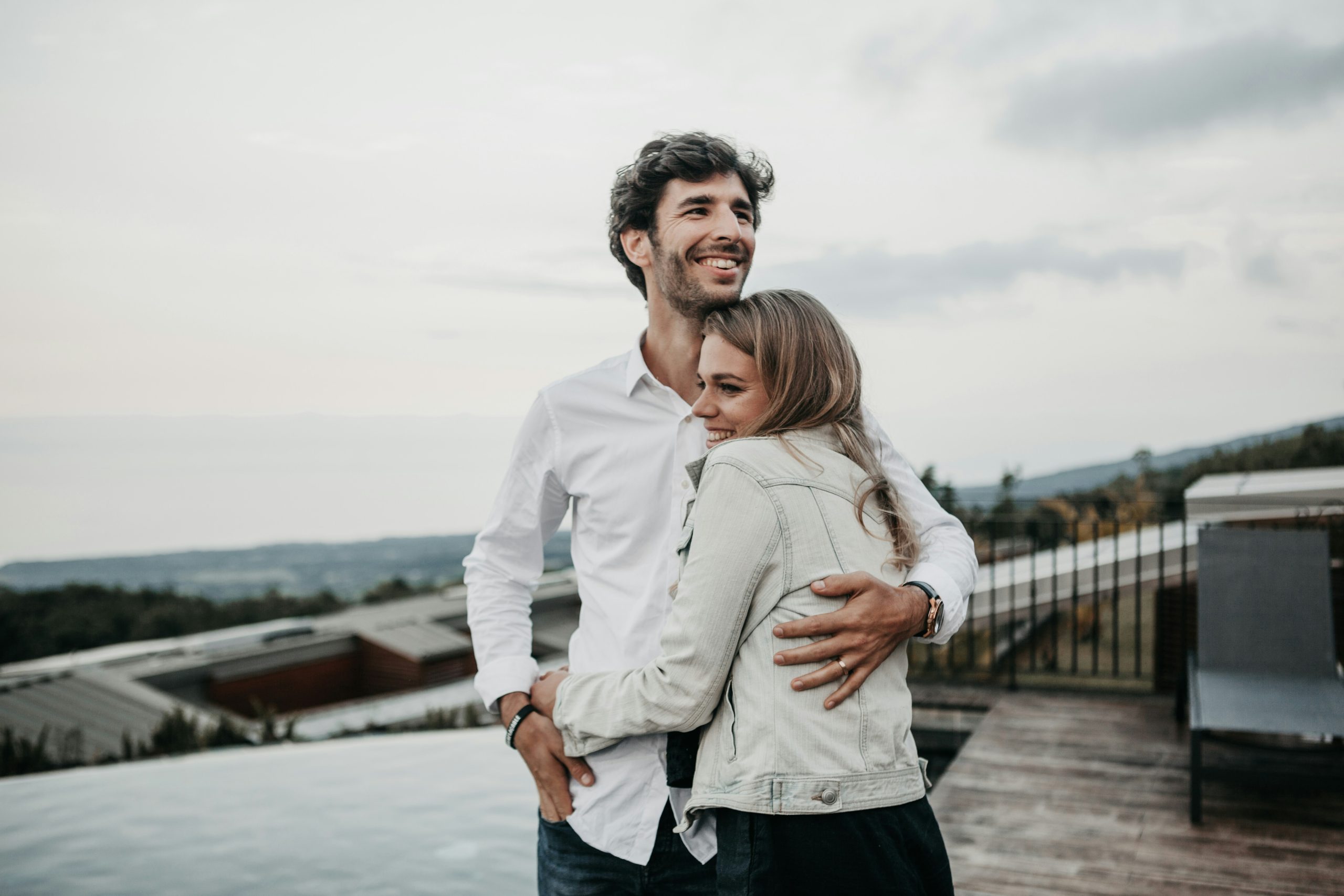 Happy couple embracing outdoors, reflecting secure attachment and emotional connection.
