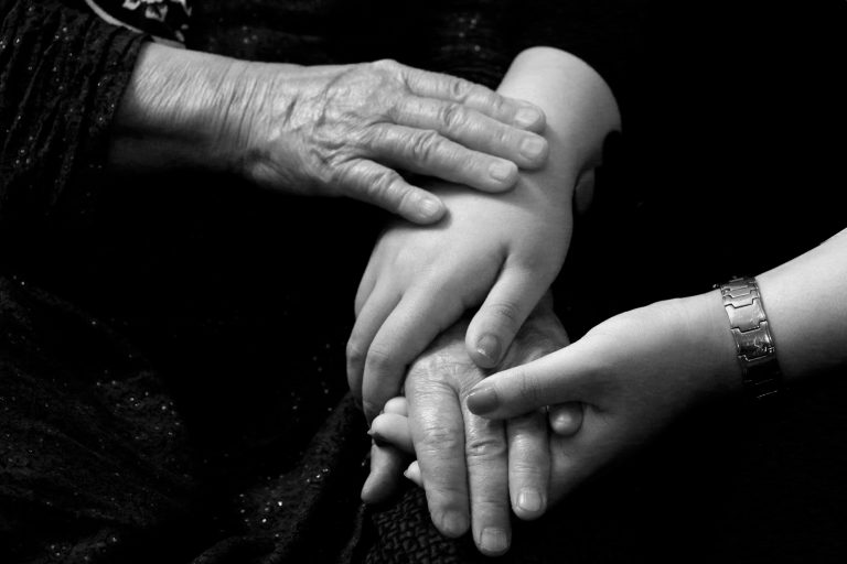 Hands across generations showing the emotional impact of role reversal.