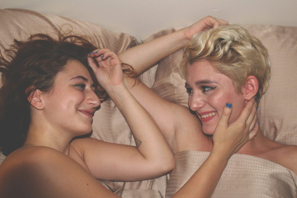 Shame healing shown in two partners connecting in bed, capturing intimacy and support to ease bedroom anxiety.