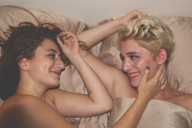 Shame healing shown in two partners connecting in bed, capturing intimacy and support to ease bedroom anxiety.