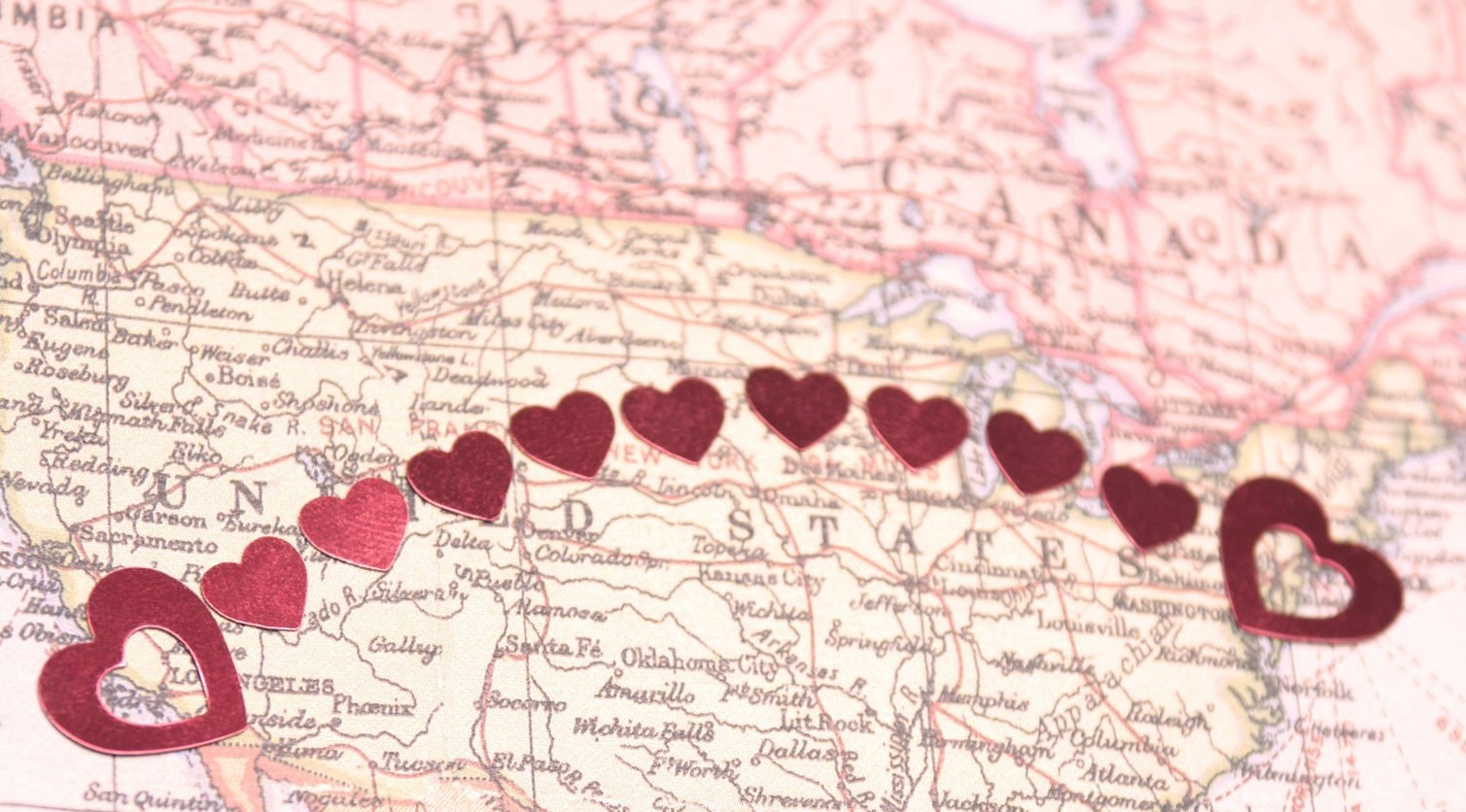 Secure attachment shown through hearts linking cities, symbolising emotional support in long-distance relationships.