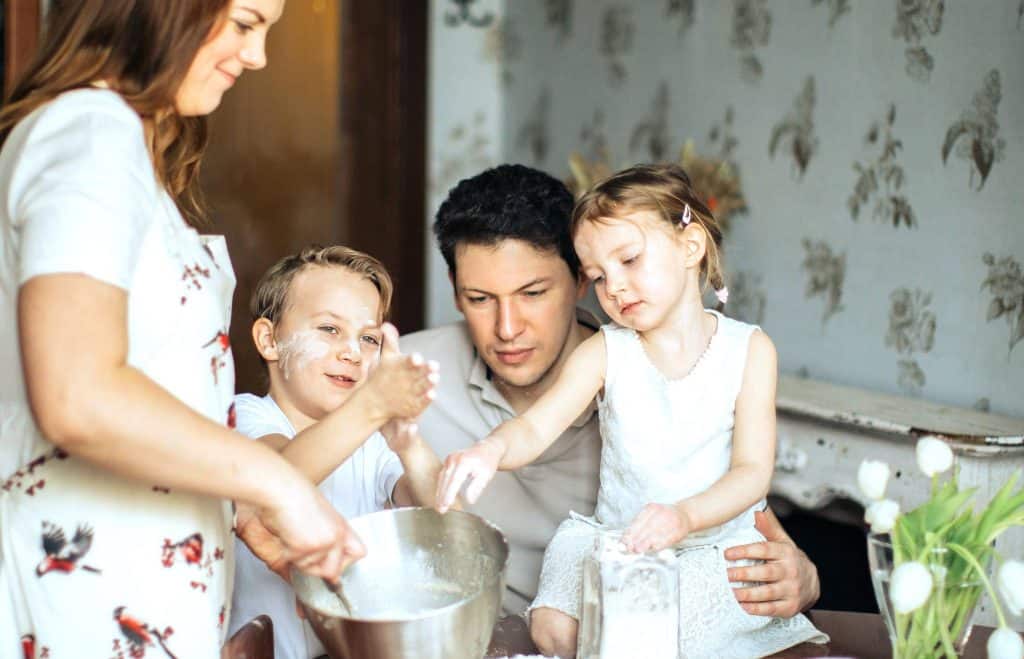 Playing with flour and dough signifies childhood innocence and creativity, offering a sensory experience that can promote emotional well-being and mindfulness. It also highlights the importance of playful learning and family bonding.