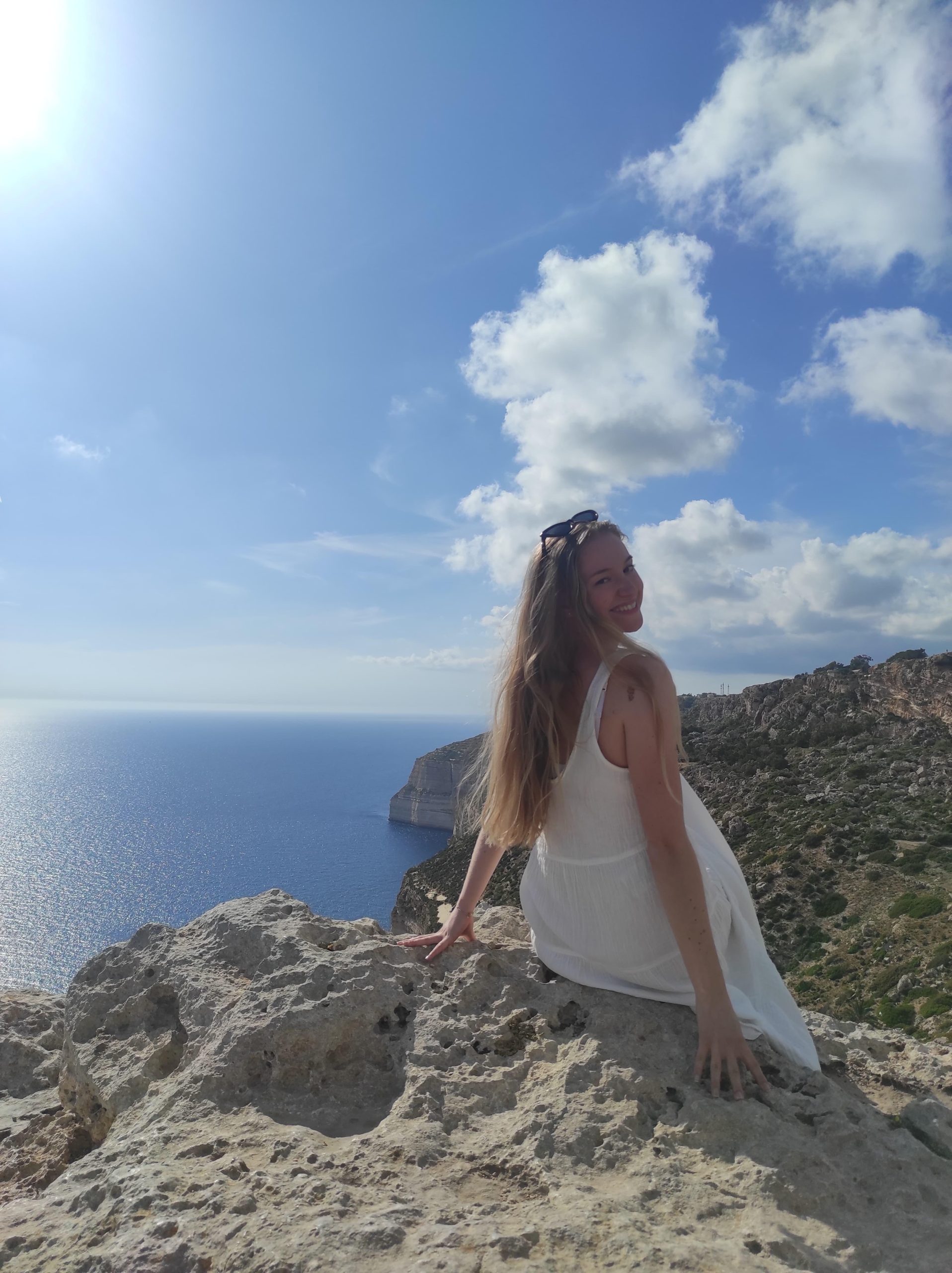 Una Batinic enjoying Malta’s cliffs, reflecting on her internship journey and growth at Willingness Malta – Una Batinic Reflections.