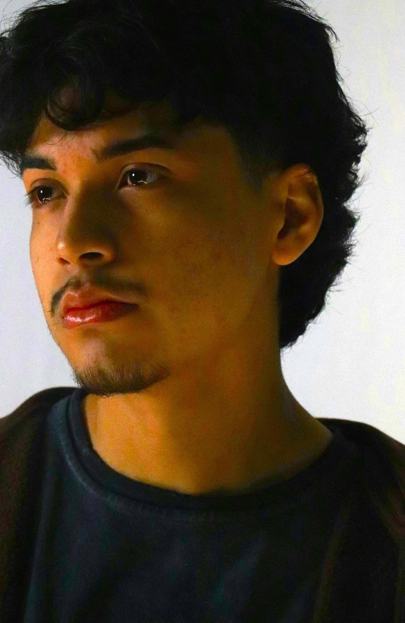 Young man with contemplative expression, highlighting mental health awareness and emotional well-being.