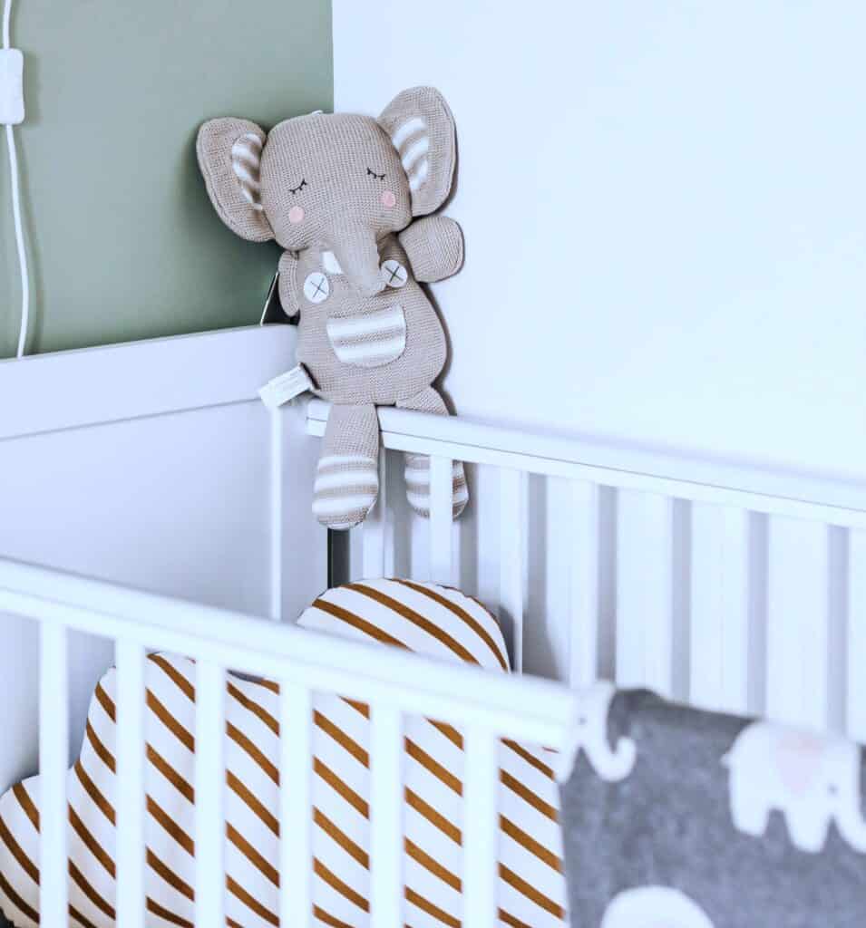 Empty cot with soft toy elephant, symbolising miscarriage grief, lost expectations, and Broken Parent Dreams.
