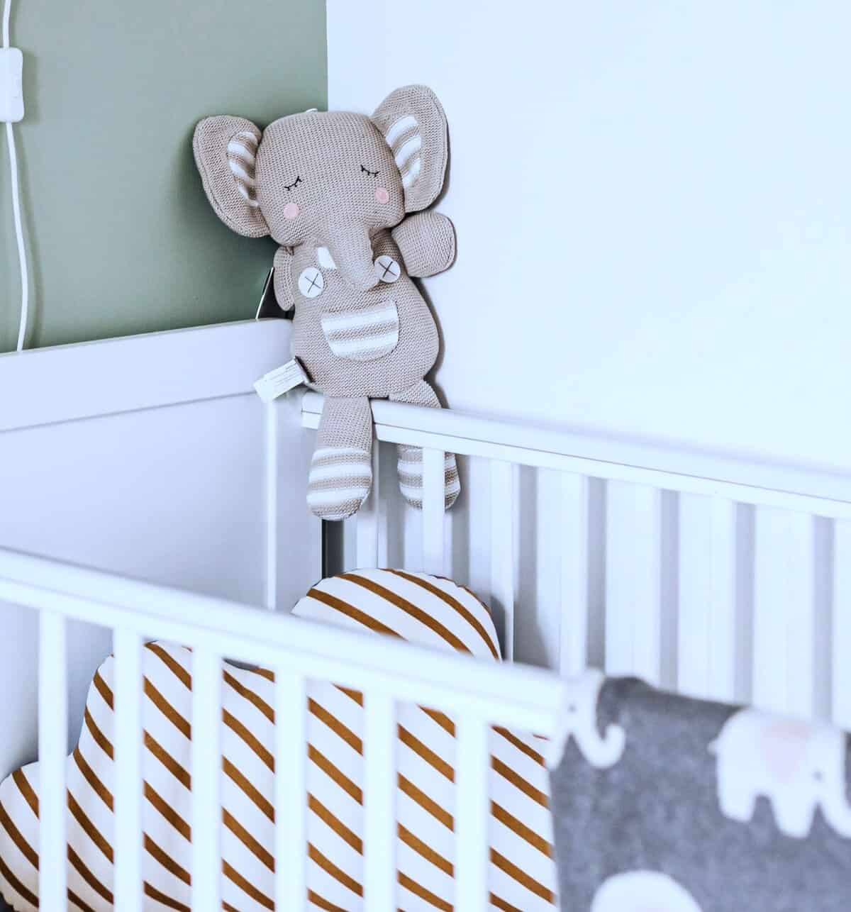 Empty cot with soft toy elephant, symbolising miscarriage grief, lost expectations, and Broken Parent Dreams.