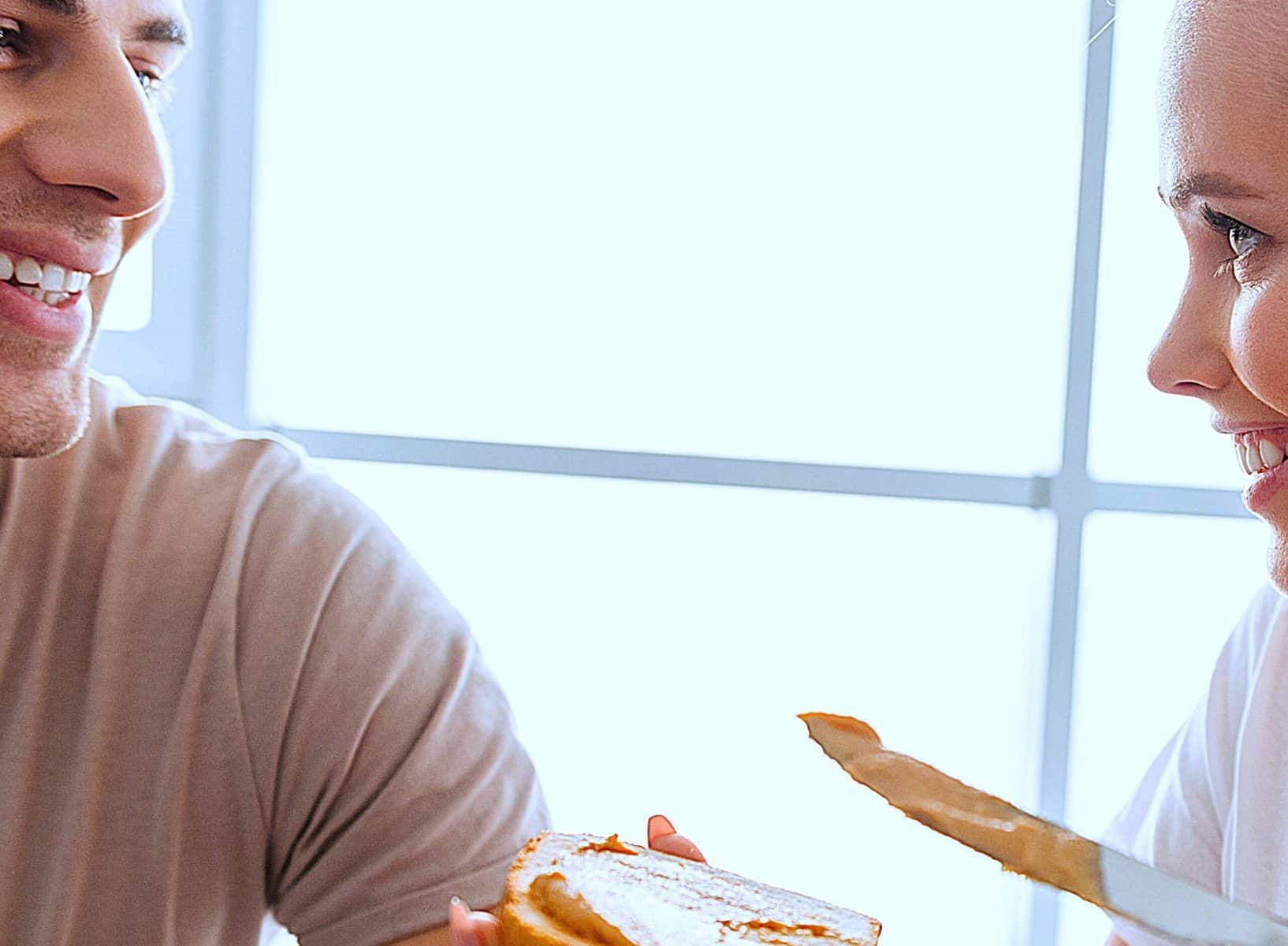 A joyful couple sharing breakfast symbolising Morning Rituals For Love, connection, and consistent happy daily routines.