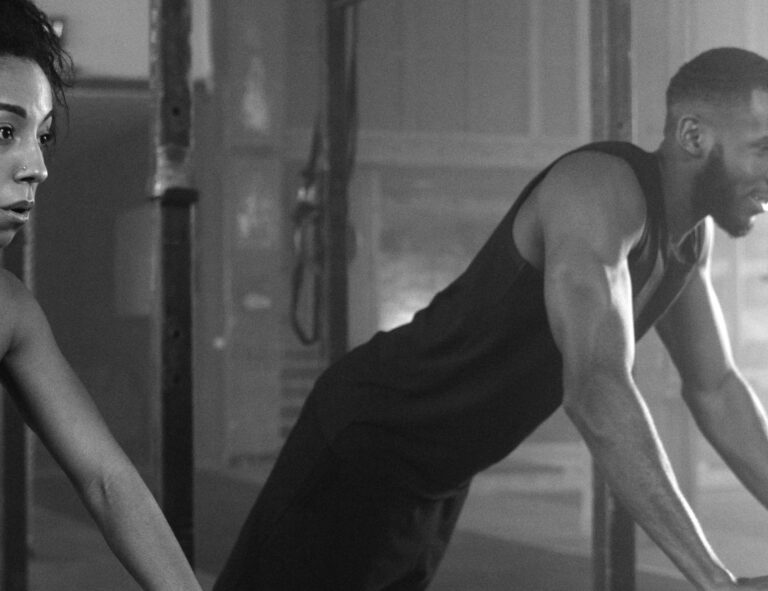 Couple engaging in Bonding Workouts at the gym, building trust, intimacy, and shared fitness commitment.