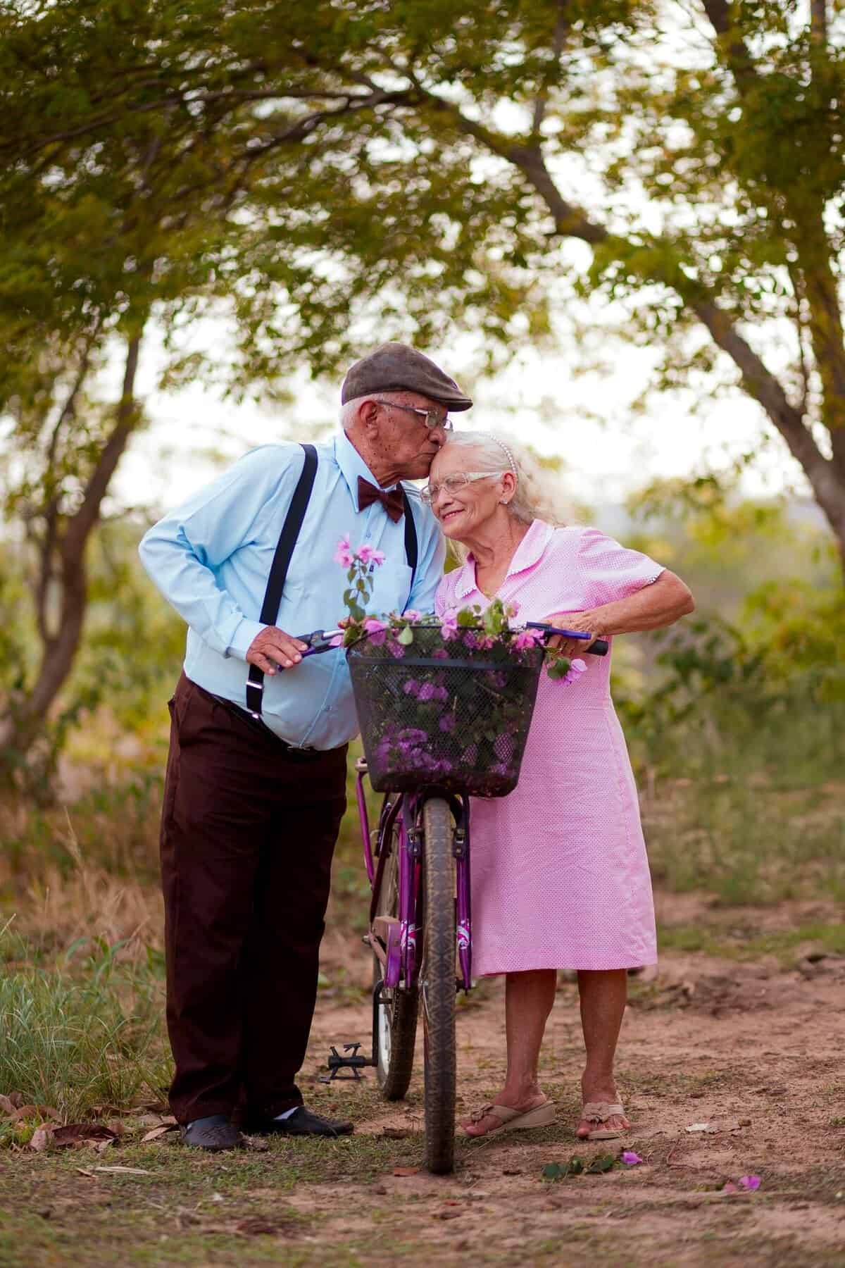 Elderly couple enjoying a tender moment by bike, representing wellness despite Senior Health Medication Risks.