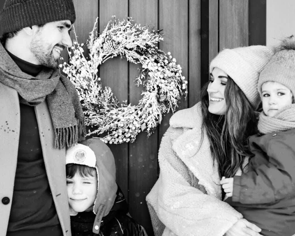 A happy family smiling outdoors, showing how Christmas Parenting Coordination brings harmony between two separate homes.