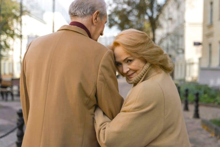 Older couple enjoying time together outdoors, reducing loneliness through Qualified Elderly Support.
