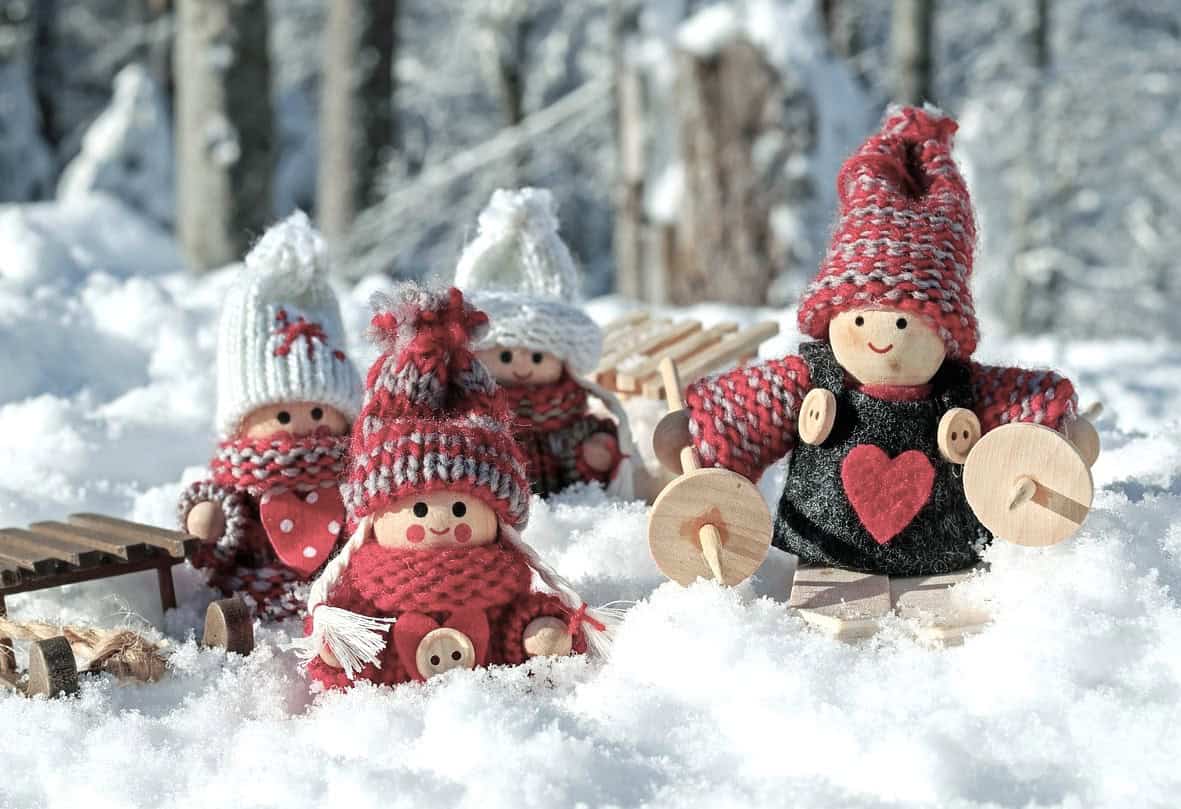 Cosy wooden dolls in the snow represent family dynamics, recovery and emotional healing after Triggering Conversations.